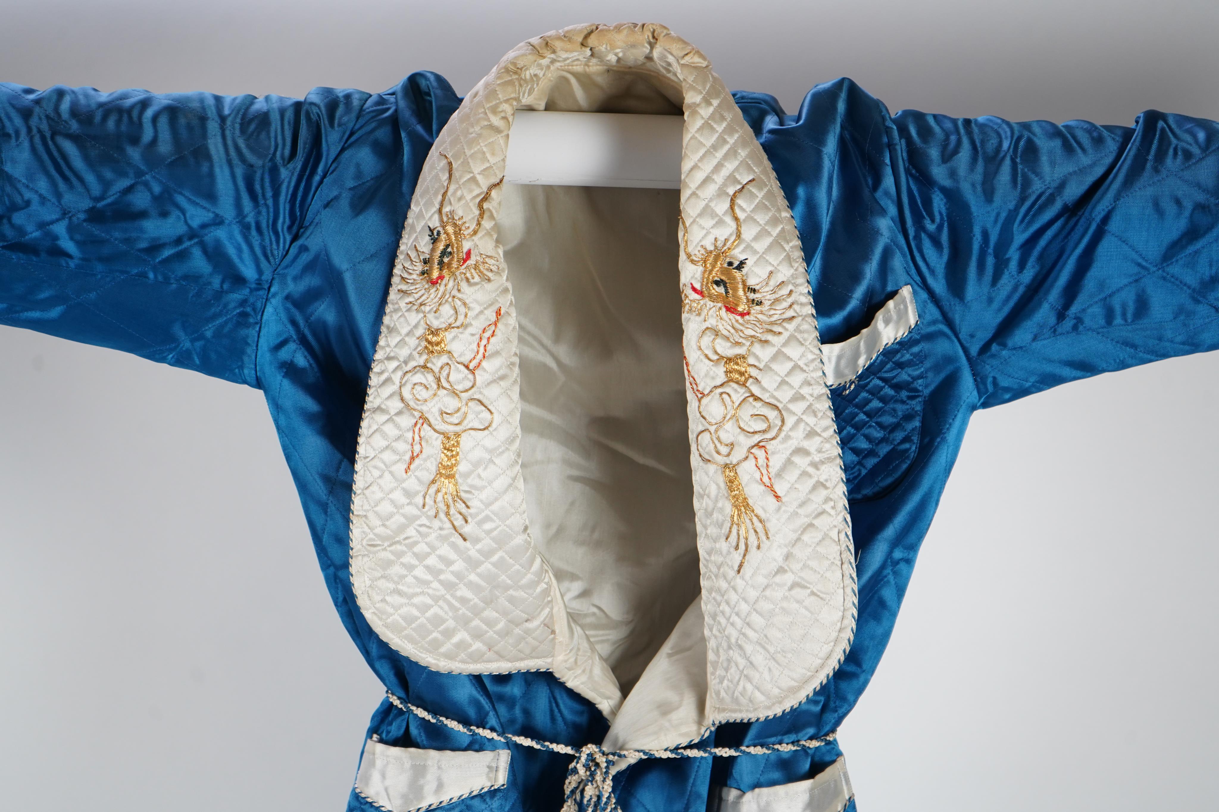 A mid 20th century Royal blue satin gentleman’s smoking jacket and matching dressing gown with Chinese gold dragon embroidery to both the quilted collars and cuffs, measurement from top back of collar to bottom of dressi